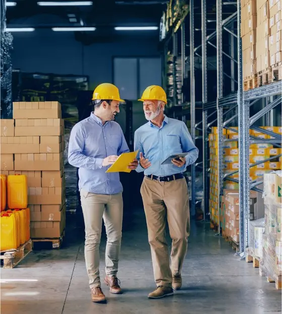Two men discussing in a warehouse about Enterprise Software Development