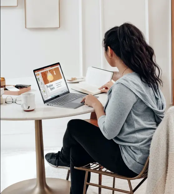 Woman working on a laptop for Content Marketing Service at a home table