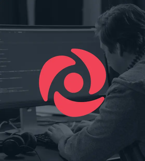 Developer coding with red swirl logo on screen