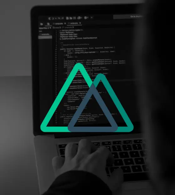 Man working on laptop with overlayed triangle logo