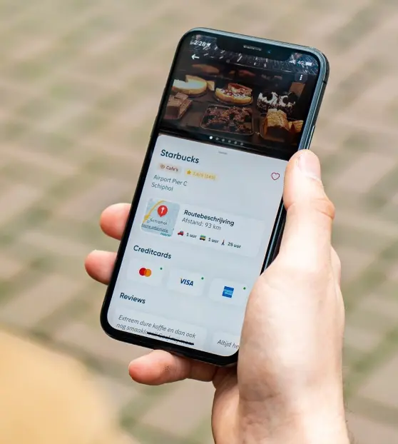 Person holding a smartphone displaying a cafe app