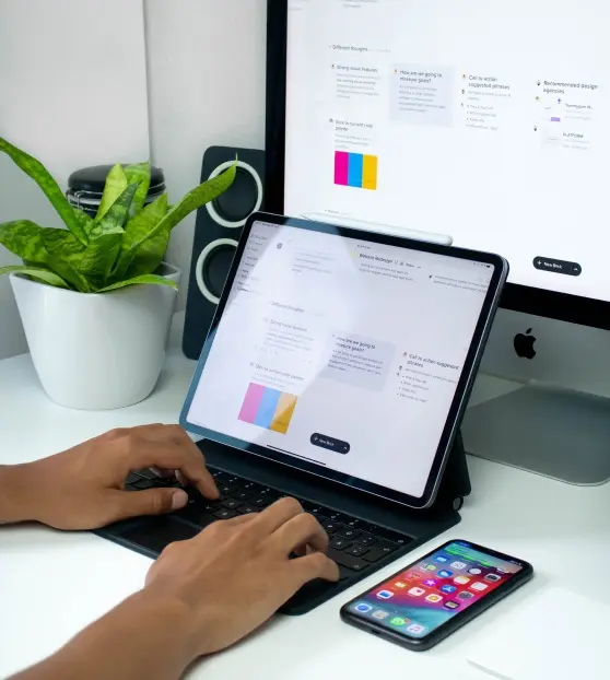 Person using a tablet and keyboard in a modern workspace