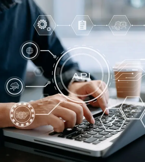 Person typing on a laptop with API graphics overlay