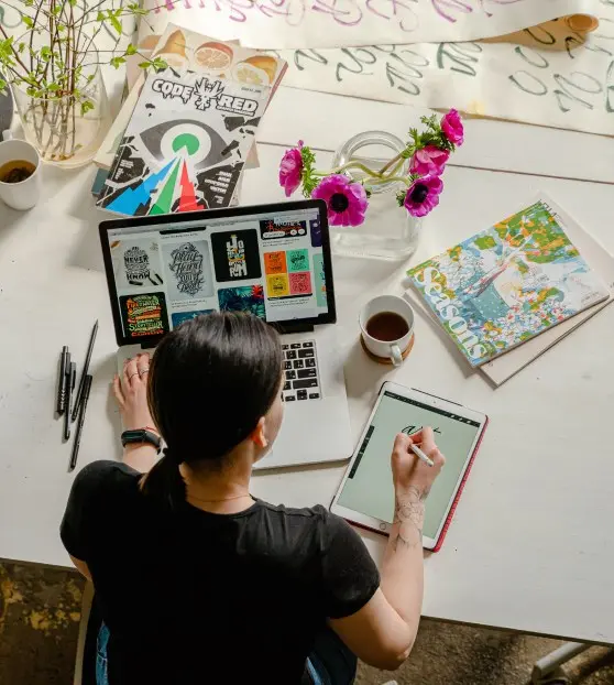 Designer working on digital artwork at a desk