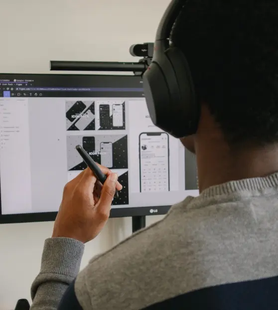 Designer working on digital mockups with headphones