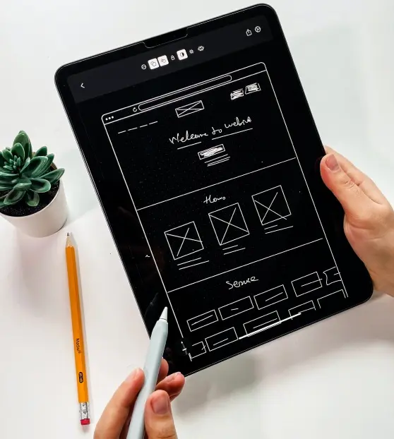 Tablet displaying a wireframe design for a website.