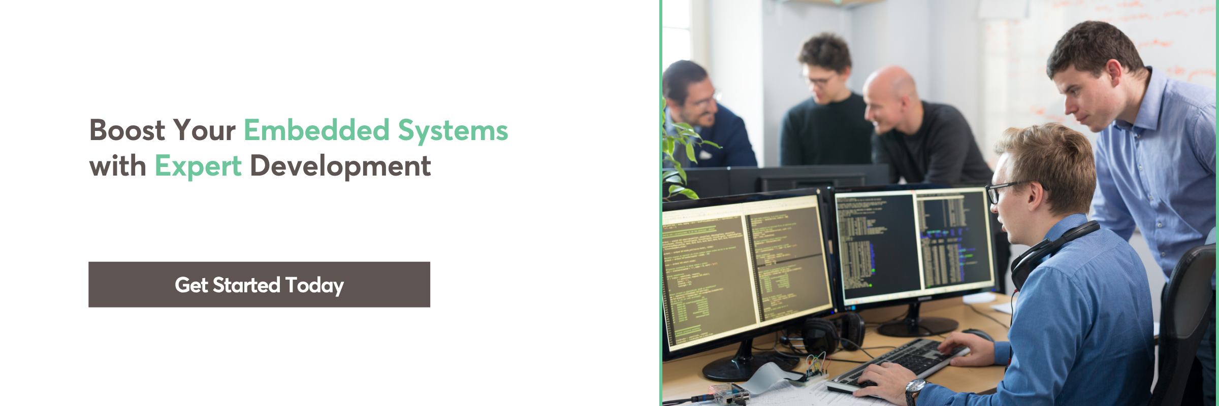 Team working on embedded software development with dual monitor setup.